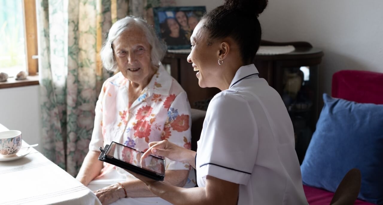 Patient receiving care enhanced by tablet device supported by Three Business's 5G network.