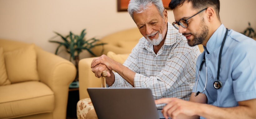 Patient receiving care enhanced by laptop device supported by Three Business's 5G network.