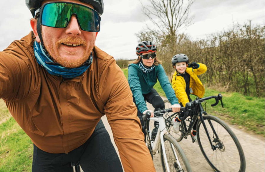 Man, woman and child on bikes. Tracking a cycle journey with paired smartwatches